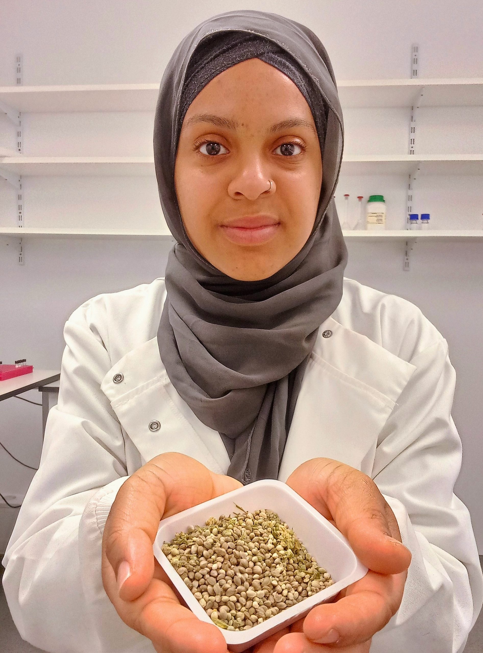 Jamila La-Malfa Donaldson holding a small container of hemp seeds